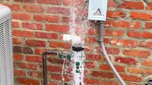 Photo of vacuum breaker exploding with water